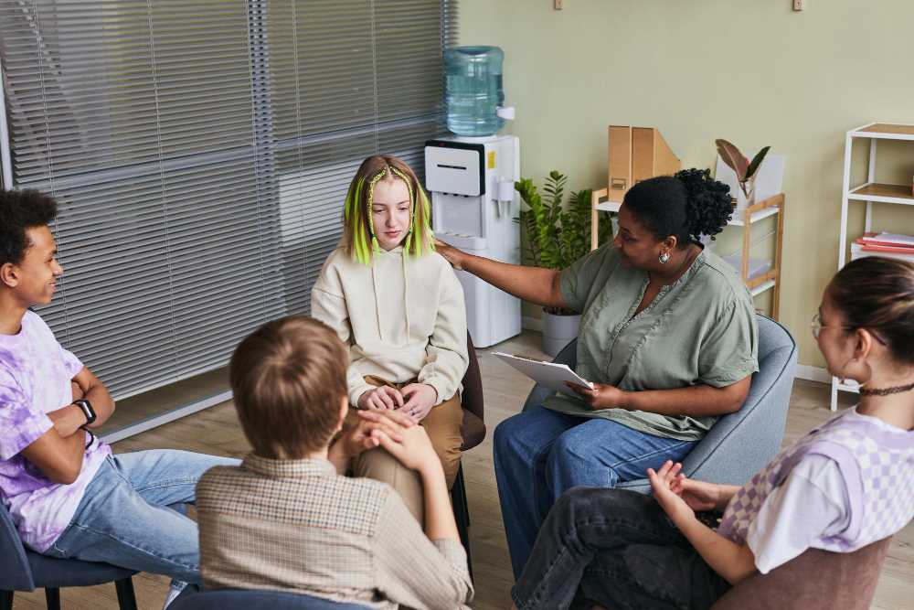 group-teenagers-sitting-chairs-talking-their-problems-psychologist-who-listening